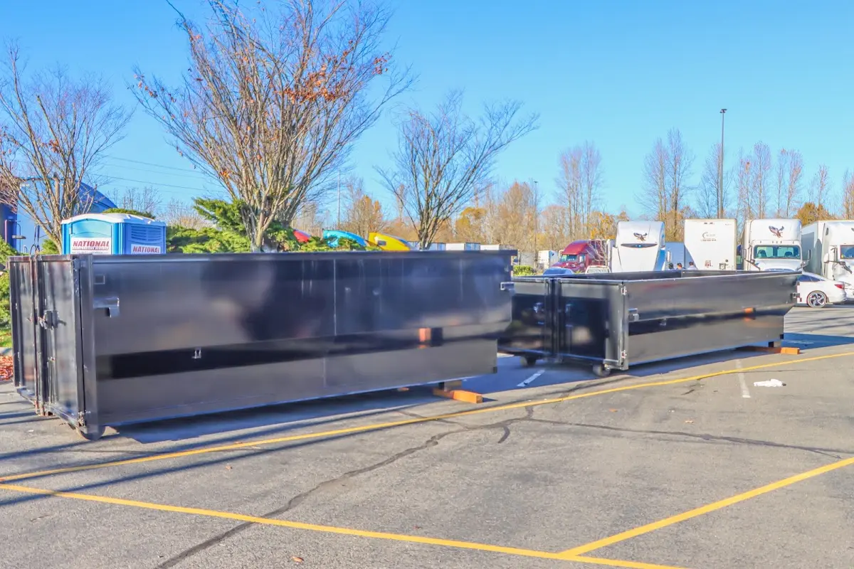 Professional dumpster rental service with roll-off container on residential driveway in Lakeland South
